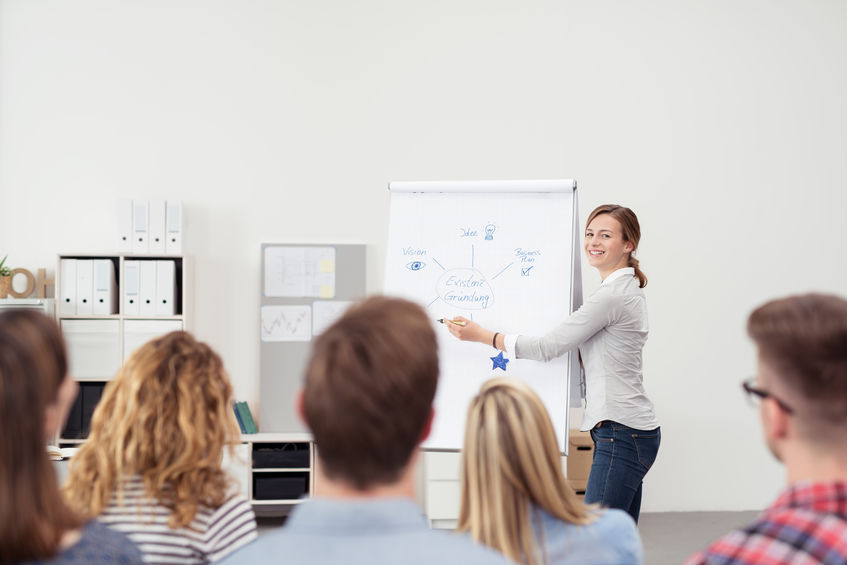 pretty team leader explaining to her colleagues pretty team leader explaining to her colleagues